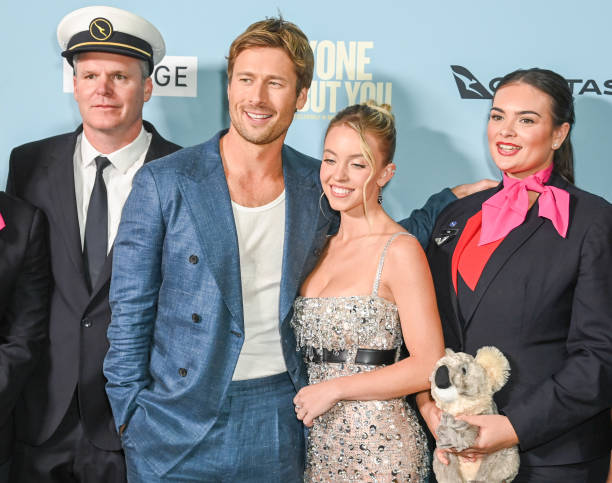 Glen Powell and Sydney Sweeney with guests from Qantas Airlines at the "Anyone But You" premiere held at AMC Lincoln Square on December 11, 2023 in New York, New York.