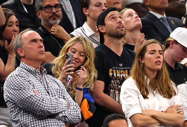 Sydney Sweeney and Scooter Braun Look on During