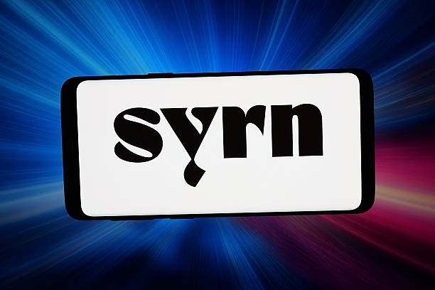In this photo illustration, the logo of US lingerie company Syrn is displayed on a smartphone in front of abstract ba...