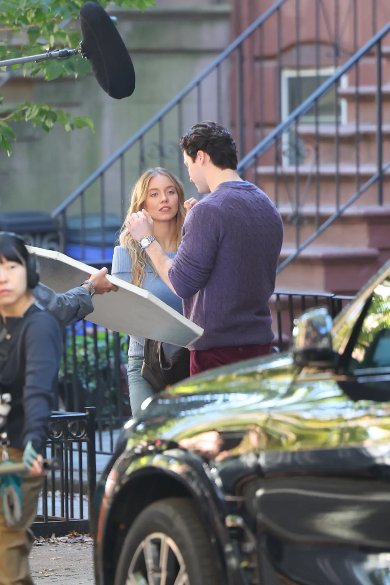Sydney Sweeney Wears a Blue Off-Shoulder Sweater on The Housemaid’s Secret Set